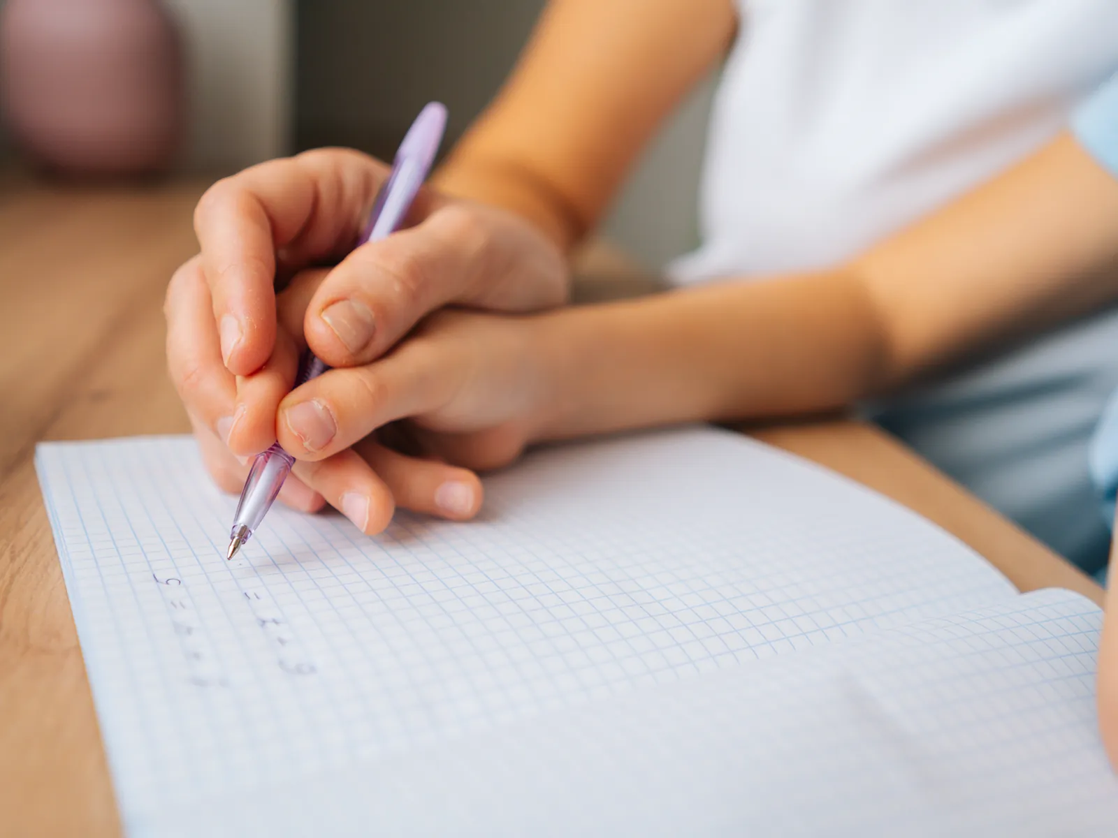 Étudiante aide un enfant de primaire à faire un exercice de calcul